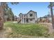 Charming two-story home with a spacious backyard, lush green lawn, and split rail fence at 1798 Summerglow Ln, Monument, CO 80132