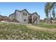 Charming two-story home with a spacious backyard, lush green lawn, and split rail fence at 1798 Summerglow Ln, Monument, CO 80132