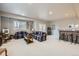 Spacious finished basement area with plush carpet, full bar, recessed lighting, and an exterior entrance at 1798 Summerglow Ln, Monument, CO 80132