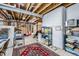 Spacious basement area featuring exposed ceiling, concrete flooring, and ample storage space at 1798 Summerglow Ln, Monument, CO 80132