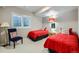 Bright bedroom with two twin beds, a sitting chair, and a window for natural light at 1798 Summerglow Ln, Monument, CO 80132