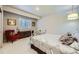 Well-lit bedroom featuring a large window, hardwood floors, ample storage, and a comfortable bed at 1798 Summerglow Ln, Monument, CO 80132