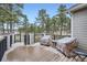 Exterior shot of the spacious deck with black railings and views of the surrounding trees and landscaping at 1798 Summerglow Ln, Monument, CO 80132