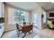 Bright dining area featuring a wooden table, large windows with views of the surrounding landscape, and light-colored walls at 1798 Summerglow Ln, Monument, CO 80132