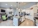 Open layout with modern kitchen flowing into the living area with stone fireplace at 1798 Summerglow Ln, Monument, CO 80132
