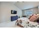 Bright main bedroom featuring vaulted ceilings, a ceiling fan, and ample natural light from the large windows at 1798 Summerglow Ln, Monument, CO 80132