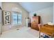 Bright office with a vaulted ceiling, large window, and traditional wooden desk and storage at 1798 Summerglow Ln, Monument, CO 80132