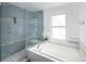 Bright bathroom with a large soaking tub, window, and glass-enclosed tile shower at 9811 Crystallo Ct, Parker, CO 80134