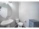 Powder bathroom with pedestal sink, modern fixtures, and a neutral color scheme at 11450 Booth Falls Ct, Parker, CO 80134