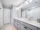 Bright bathroom featuring a double vanity, large mirror, and modern lighting fixtures at 11450 Booth Falls Ct, Parker, CO 80134