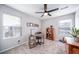 Comfortable bedroom with work space, ceiling fan, and natural light from windows at 11450 Booth Falls Ct, Parker, CO 80134