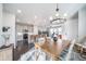 Dining room with pendant lighting, a dining table, and views into an open kitchen area at 11450 Booth Falls Ct, Parker, CO 80134