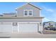 Exterior view showcasing a two-car garage and modern design elements of the home at 11450 Booth Falls Ct, Parker, CO 80134