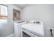 Efficient laundry room with modern washer and dryer, and window for natural light at 11450 Booth Falls Ct, Parker, CO 80134