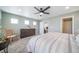 Main bedroom with ceiling fan, dresser, and abundant natural light from windows at 11450 Booth Falls Ct, Parker, CO 80134