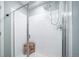 Elegant shower with white tiled walls, glass door, and a teakwood shower stool at 11450 Booth Falls Ct, Parker, CO 80134