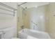 Clean bathroom featuring tiled shower over tub, grab bars, and toilet at 7801 W 35Th Ave # 409, Wheat Ridge, CO 80033