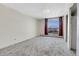 Spacious bedroom with large window featuring skyline view and neutral carpet at 7801 W 35Th Ave # 409, Wheat Ridge, CO 80033