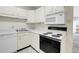 View of kitchen featuring a white oven and microwave with modern laminate countertops at 7801 W 35Th Ave # 409, Wheat Ridge, CO 80033