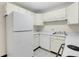 Close-up of a kitchen featuring white cabinets, appliances and laminate countertops at 7801 W 35Th Ave # 409, Wheat Ridge, CO 80033