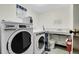 Well-lit laundry room featuring high-efficiency washer and dryer units at 7801 W 35Th Ave # 409, Wheat Ridge, CO 80033