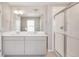 The well-lit bathroom features a double vanity, a large mirror, and a glass-enclosed shower at 1854 Westport Ave, Berthoud, CO 80513