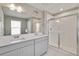 The stunning bathroom features a double vanity, a large mirror, and a glass-enclosed shower at 1854 Westport Ave, Berthoud, CO 80513