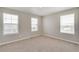 This bedroom has neutral paint, carpet and three bright windows at 1854 Westport Ave, Berthoud, CO 80513