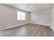 Bright living room featuring hardwood floors, lots of natural light, and an adjacent staircase at 1854 Westport Ave, Berthoud, CO 80513