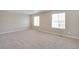 A spacious primary bedroom features carpeting and large windows for great natural light at 1854 Westport Ave, Berthoud, CO 80513