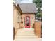 Inviting front porch with a bright red door, brick detailing and a cozy seating area at 983 S Josephine St, Denver, CO 80209