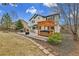 Well-maintained backyard features hot tub, patio, and mature trees at 5885 Kingsfield St, Castle Rock, CO 80104