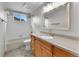 Bathroom with vanity, mirror, lighting, and shower-tub combo with tiled walls at 5885 Kingsfield St, Castle Rock, CO 80104