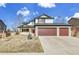 Charming two-story home with a three-car garage and well-maintained front yard at 5885 Kingsfield St, Castle Rock, CO 80104
