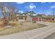 Beautiful two-story home with a three-car garage and front yard with mature tree at 5885 Kingsfield St, Castle Rock, CO 80104