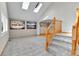 Bright foyer featuring skylights, tile flooring, and a staircase with wood railings at 5885 Kingsfield St, Castle Rock, CO 80104