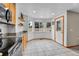 Eat-in kitchen featuring granite counters, white tile floors, and lots of natural light at 5885 Kingsfield St, Castle Rock, CO 80104