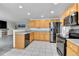 Modern kitchen with stainless steel appliances, granite countertops, and wood cabinets at 5885 Kingsfield St, Castle Rock, CO 80104