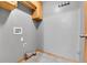 Functional laundry room features tile flooring, cabinet storage and utility hookups at 5885 Kingsfield St, Castle Rock, CO 80104