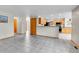 Open-concept living room with tile floors and open view to the modern kitchen at 5885 Kingsfield St, Castle Rock, CO 80104