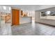 Open-concept living room features tile flooring, neutral walls, and a large window for natural light at 5885 Kingsfield St, Castle Rock, CO 80104