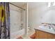 Main bathroom features a shower-tub combo and dual vanity sinks, perfect for a growing Gathering at 12728 Jasmine St # E, Thornton, CO 80602