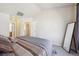 Bright bedroom featuring neutral walls, carpet floors, and large mirror at 12728 Jasmine St # E, Thornton, CO 80602