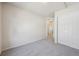 Neutrally decorated bedroom featuring a closet and carpeted floors at 12728 Jasmine St # E, Thornton, CO 80602