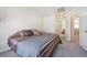 Bedroom with neutral carpet and ensuite access to bathroom at 12728 Jasmine St # E, Thornton, CO 80602