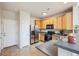 Well-equipped kitchen with wooden cabinetry, modern appliances, and ample counter space for cooking at 12728 Jasmine St # E, Thornton, CO 80602