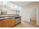Bright kitchen features stainless steel dishwasher, double basin sink, and access to a convenient half bathroom at 12728 Jasmine St # E, Thornton, CO 80602