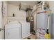 Utility room with side-by-side washer, dryer, water heater and HVAC system at 12728 Jasmine St # E, Thornton, CO 80602