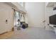 Bright and airy living room featuring a high ceiling, large windows, and stylish decorative accents at 12728 Jasmine St # E, Thornton, CO 80602