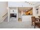 Bright living room featuring an open floor plan that connects to the kitchen and dining area at 12728 Jasmine St # E, Thornton, CO 80602